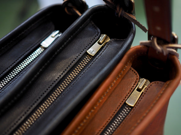 Black leather purse with nickel zipper.  Black leather purse with antique brass zipper.  Brown leather purse with antique brass zipper.